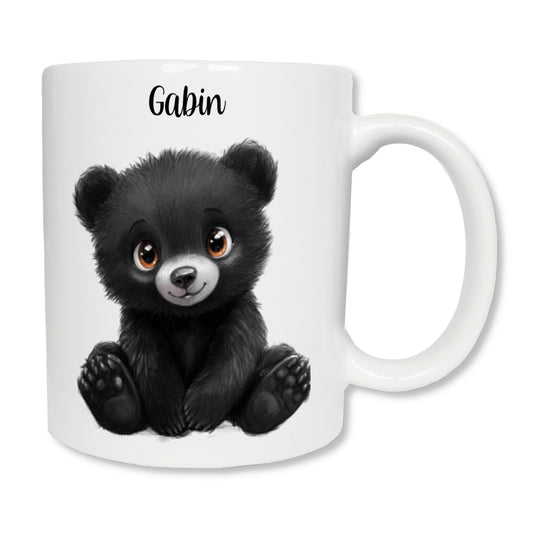 Mug blanc en céramique avec un dessin représentant un ourson noir assit de face