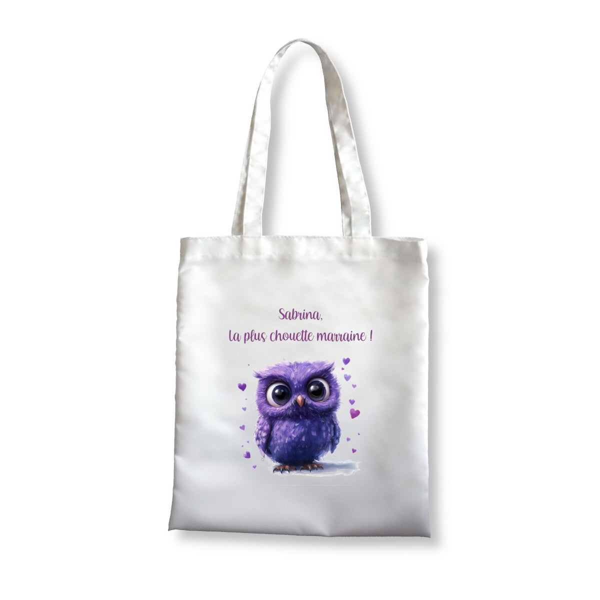 Totebag blanc avec un dessin d'une chouette violette avec de gros yeux et entourée de coeurs.