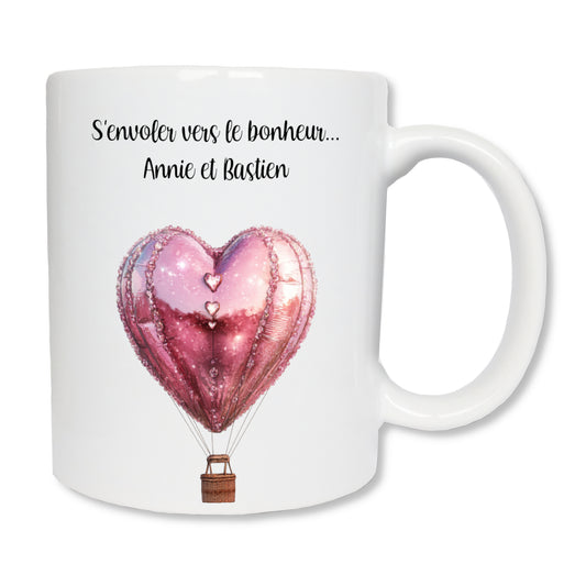 Mug blanc en céramique avec un dessin représentant une montgolfière en forme de coeur rose qui s'envole