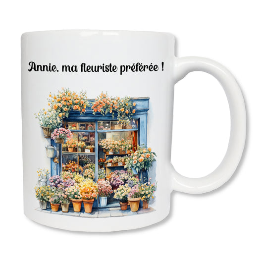 Mug blanc en céramique de 325ml avec un dessin représentant la vitrine d'un magasin de fleurs avec pleins de fleurs et de bouquets et personnalisé avec votre texte. Cadeau pour fleuriste.